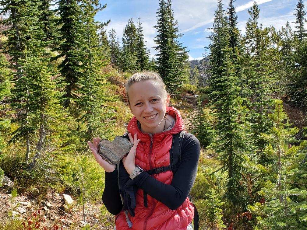 Ms. Krause holding a heart-shaped rock on her way to Heart Lake